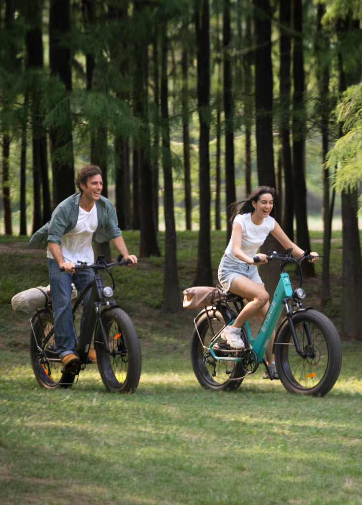 a man riding galaxy grey engwe e26 and a woman riding gem blue engwe e26